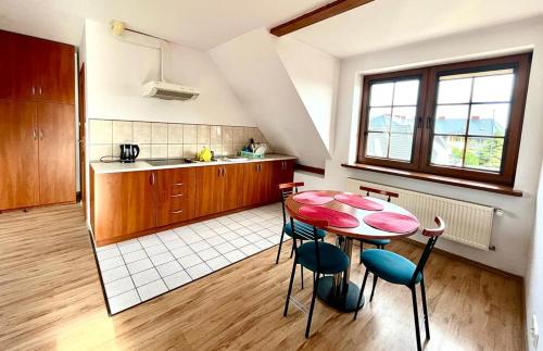 a kitchen with a table and chairs in a room at Willa Julia in Karwia
