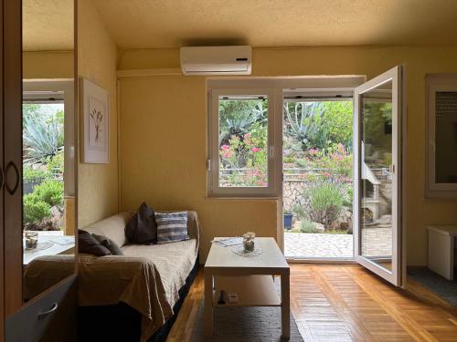 a living room with a couch and a table at Prizna Apartments in Prizna