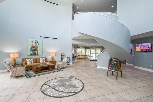 a living room with a couch and a staircase at Beachfront Retreat- "The Getaway" in Destin