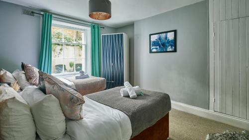 a living room with a bed and a window at Stylish 2 BR in Clifton - Garden in Bristol