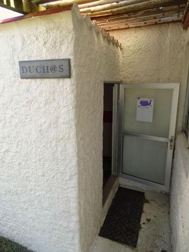 a door to a building with a sign on it at Carmela Suites Cabo Polonio in Cabo Polonio