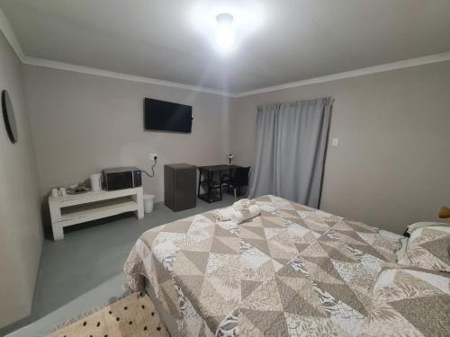 a bedroom with a bed and a television in it at 19 on Gordon in East London