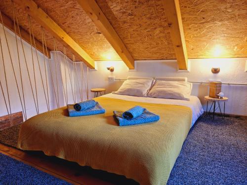 a bedroom with a large bed with blue towels on it at Kuća za odmor Matovilka in Križevci