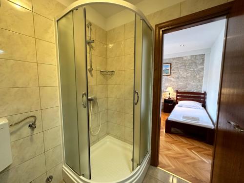 a bathroom with a shower with a glass door at Villa Dante with swimming pool in Trogir
