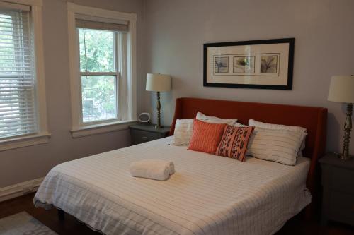 a bedroom with a large bed with pillows at 3 Level 4 Bedroom Home w/ Parking in Adams Morgan in Washington