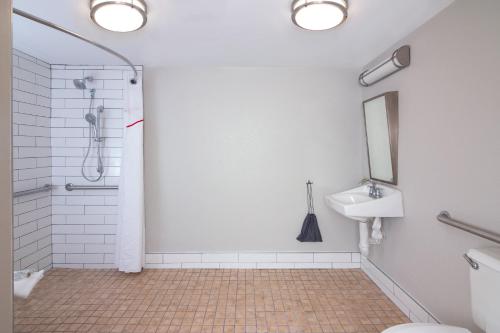 a bathroom with a shower and a sink at Red Roof PLUS Miami Airport in Miami