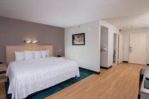 a hotel room with a large bed in a room at Red Roof PLUS Miami Airport in Miami