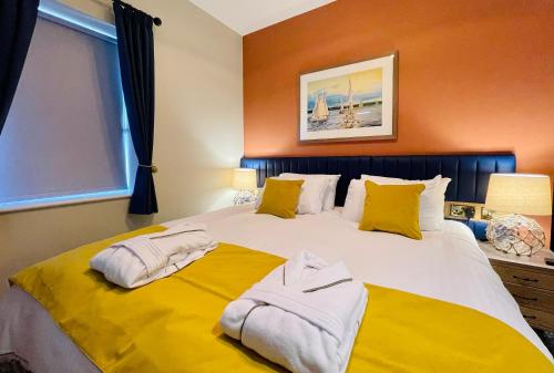 a bedroom with a large bed with towels on it at Rooms at Haslar Marina in Gosport