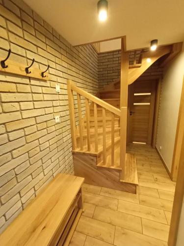 a room with a staircase and a wooden bench at Domek Szarotka in Zakopane
