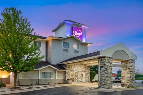 a hotel with a sign on top of it at Sleep Inn Naperville - Chicago in Naperville