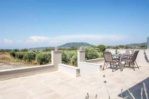 a patio with a table and chairs and a view at Thalia's House in Pastida