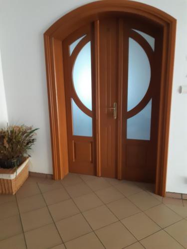 a wooden door with a window on a tile floor at Willa Julia in Karwia
