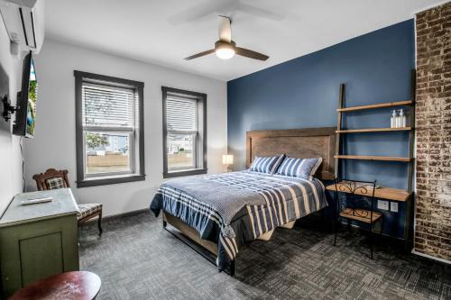 a bedroom with a bed and a ceiling fan at Webber Hotel in Lyndonville