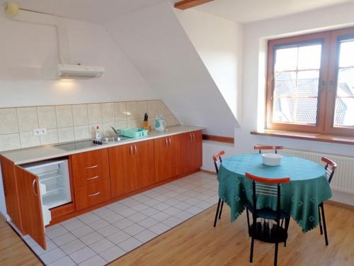 a kitchen with a table with a blue table cloth on it at Willa Julia in Karwia