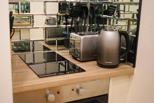 a coffeemaker sitting on a counter in a kitchen at Novana Aparthotel in Glasgow