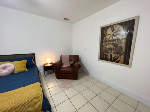 a bedroom with a bed and a chair in it at Spacious Studio - minutes from MIA airport in Miami