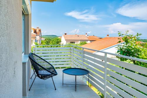 a chair and a table on a balcony at VILLA Matija in Ližnjan