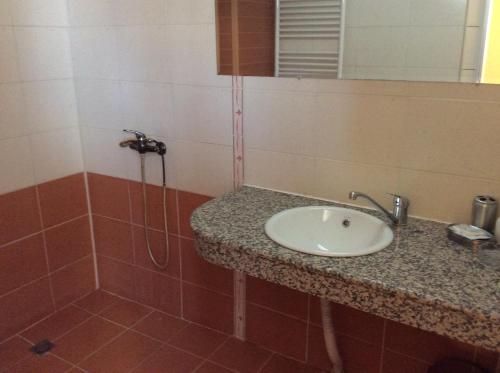 a bathroom with a sink and a shower at National Hotel in Ruse