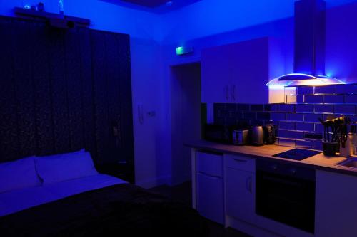a kitchen with blue lights in a room at Novana Aparthotel in Glasgow