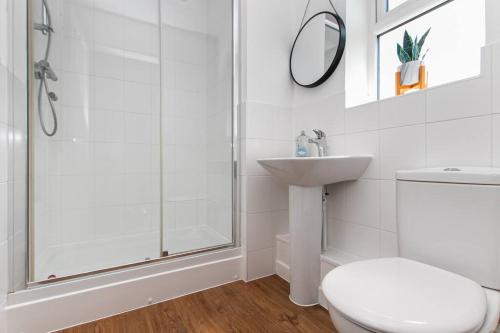 a bathroom with a shower and a toilet and a sink at Central Stylish House in Colchester in Colchester