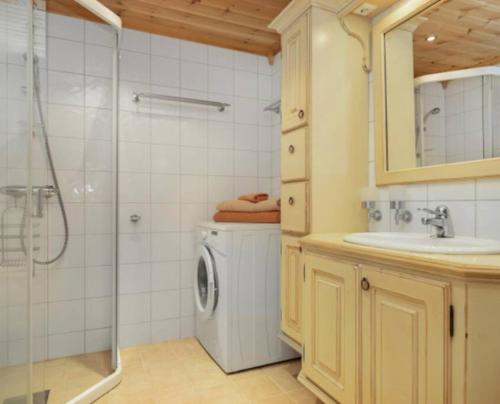 a bathroom with a washing machine and a shower at Leilighet sentralt på Beitostølen in Beitostøl