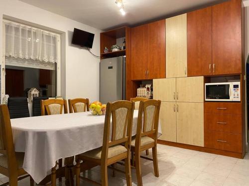 a kitchen with a table and chairs and a kitchen with a kitchen at Zsuzsi Vendégház Visz in Visz