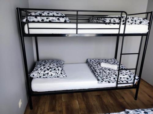 a room with three bunk beds in a room at Silver 58 Zator in Zator