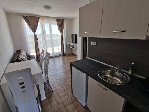 a kitchen with a sink and a counter top at Arapya Apartments in Tsarevo