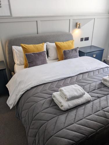a bedroom with a large bed with two towels on it at Self-Catering Suite in rural guest house 10 min to Islay Ferry Terminal in Ronachan