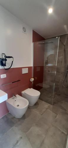 a bathroom with a toilet and a shower and a sink at Locanda Göghin in Pieve Ligure