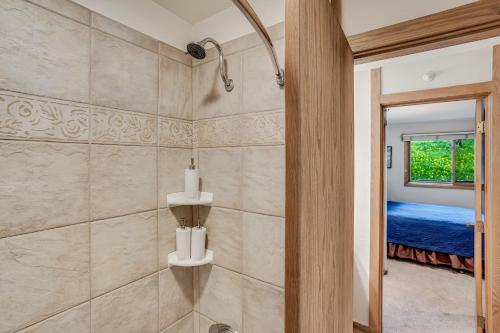 a bathroom with a walk in shower next to a door at Laurelwood Condominiums 405 in Snowmass Village