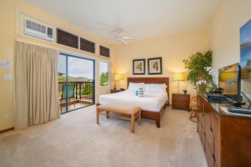 a bedroom with a bed and a balcony at Kapalua Villas Maui in Lahaina