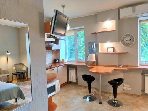 a room with a kitchen with a table and a desk at Great view apartaments near Lavra in Kyiv