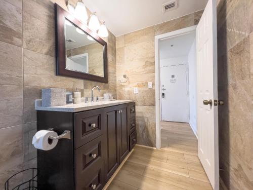 a bathroom with a sink and a mirror at Meet Me On Ocean Dr - Cozy Stay Steps From Beach in Miami Beach
