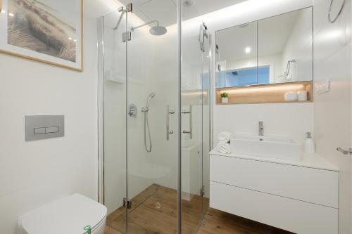 a bathroom with a shower and a toilet and a sink at Pinea 718 SeaView in Pobierowo