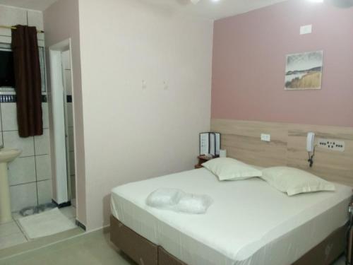 ein Schlafzimmer mit einem großen Bett und einer Dusche in der Unterkunft Hotel Faf's in São Paulo