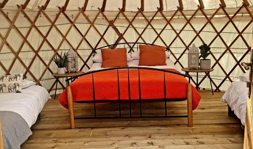 a bedroom with a bed in a yurt at The Wood Yurt in Tullow
