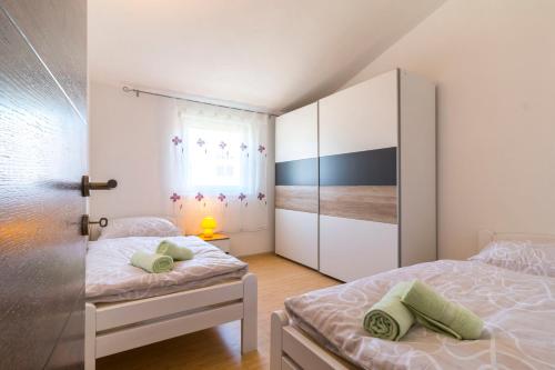 a small bedroom with two beds and a closet at Apartment Hilda in Solin