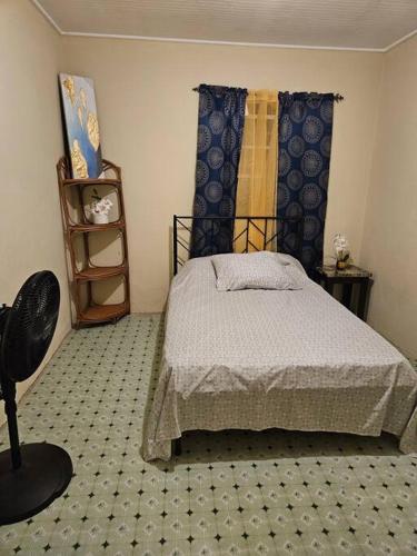 een slaapkamer met een bed en een stoel erin bij Sunset Breeze in Pointe Michel