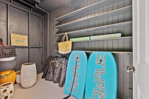 a room with two blue surfboards on a shelf at Cabana Isla- Hot Tub- Boat RV- Mins to DT & Beach in St. Augustine