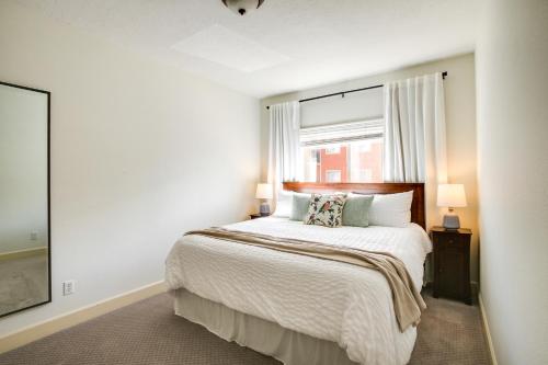 a white bedroom with a bed and a window at Coeur dAlene Condo Rental 4 Mi to Lake Hayden! in Coeur d'Alene