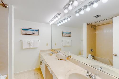 a bathroom with a sink and a large mirror at Edgewater Beach Resort 1301 in Destin