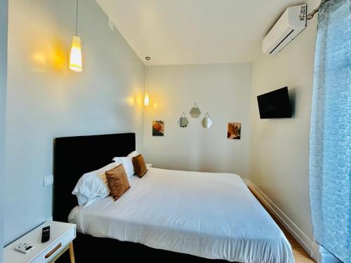 Ein Bett oder Betten in einem Zimmer der Unterkunft Plaza House Ílhavo