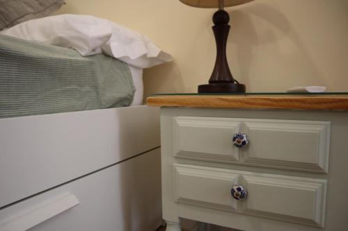 a dresser with two drawers and a lamp on it at Atocha Boutique Badajoz in Badajoz