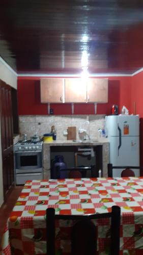 een keuken met een tafel en een koelkast bij Como en casa in Campo Grande