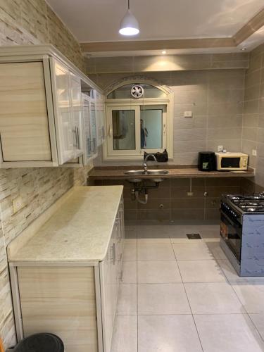 a kitchen with a sink and a counter top at New Cairo Apartment in Cairo