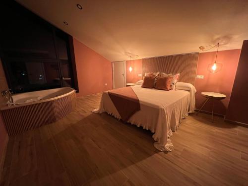 a bedroom with a bed and a bath tub at Casal de pelaio in Barreiros
