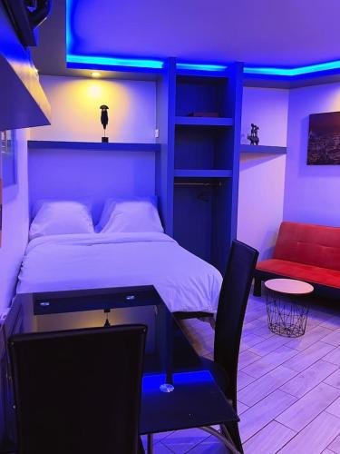 - une chambre avec un lit, une table et une chaise dans l'établissement charmant studio, à Vaulx-en-Velin