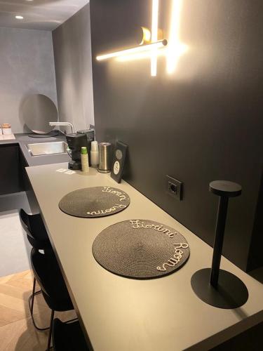 a kitchen counter with two stools on top of it at Fiorini Rooms Sora in Sora