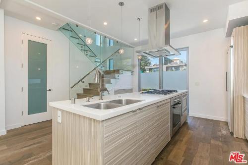 a kitchen with a sink and a staircase at Brooks Villa in Los Angeles